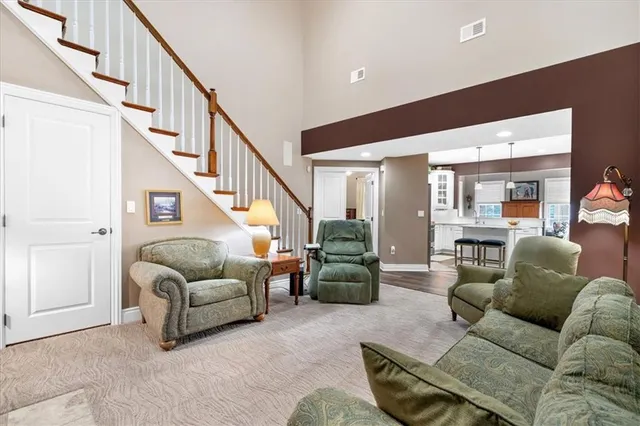 a living room with furniture and stairs