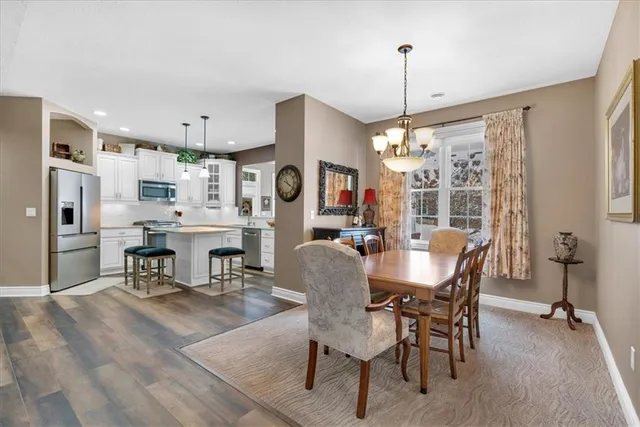a dining room with furniture and window