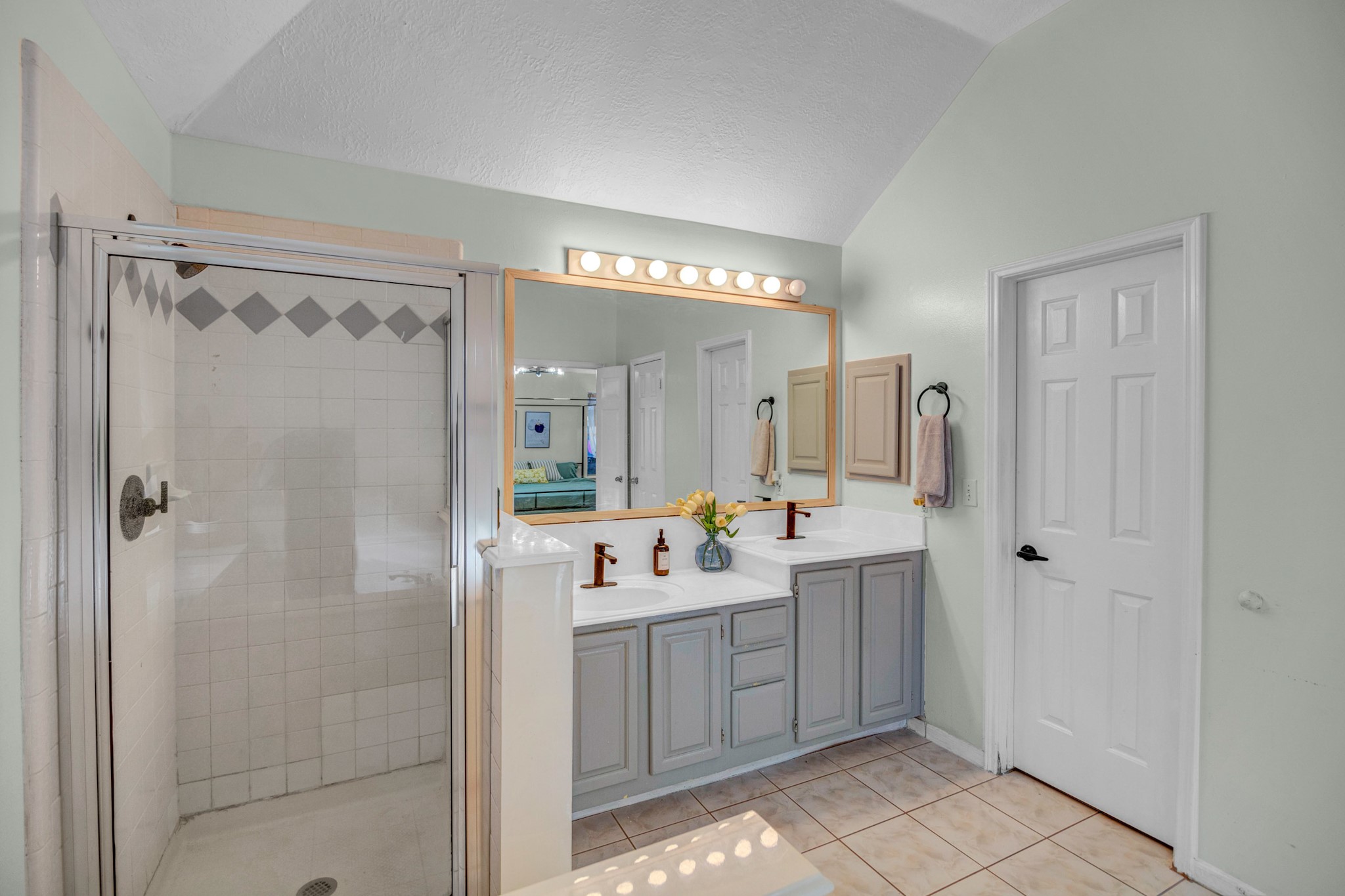 8222 Viny Ridge Drive Houston, TX 77083 - Photo 23 of 34 a bathroom with a double vanity sink mirror and shower