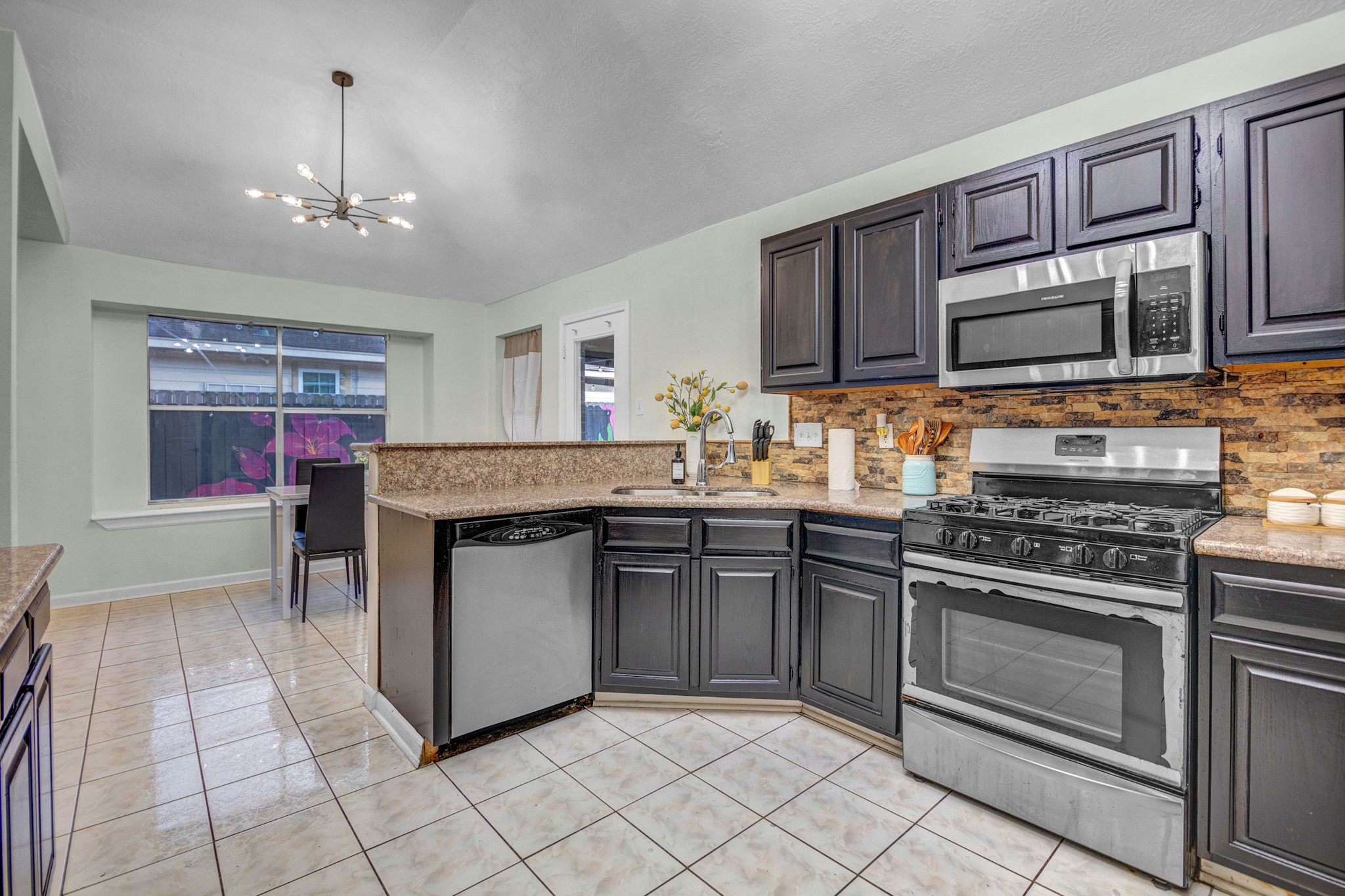8222 Viny Ridge Drive Houston, TX 77083 - Photo 7 of 34 a kitchen with a stove sink and cabinets