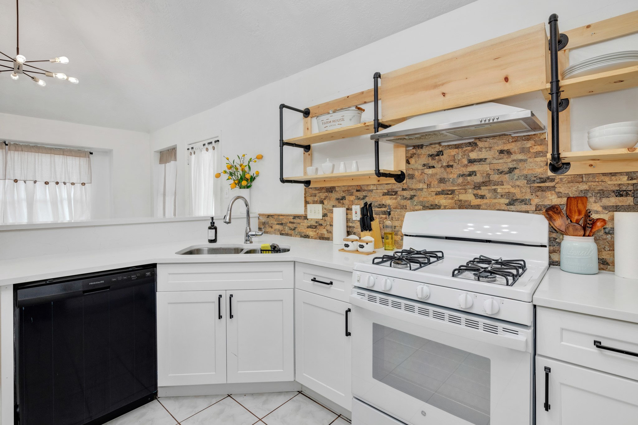 8222 Viny Ridge Drive Houston, TX 77083 - Photo 10 of 34 a kitchen with white cabinets and appliances