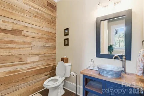 a bathroom with a toilet a sink and mirror