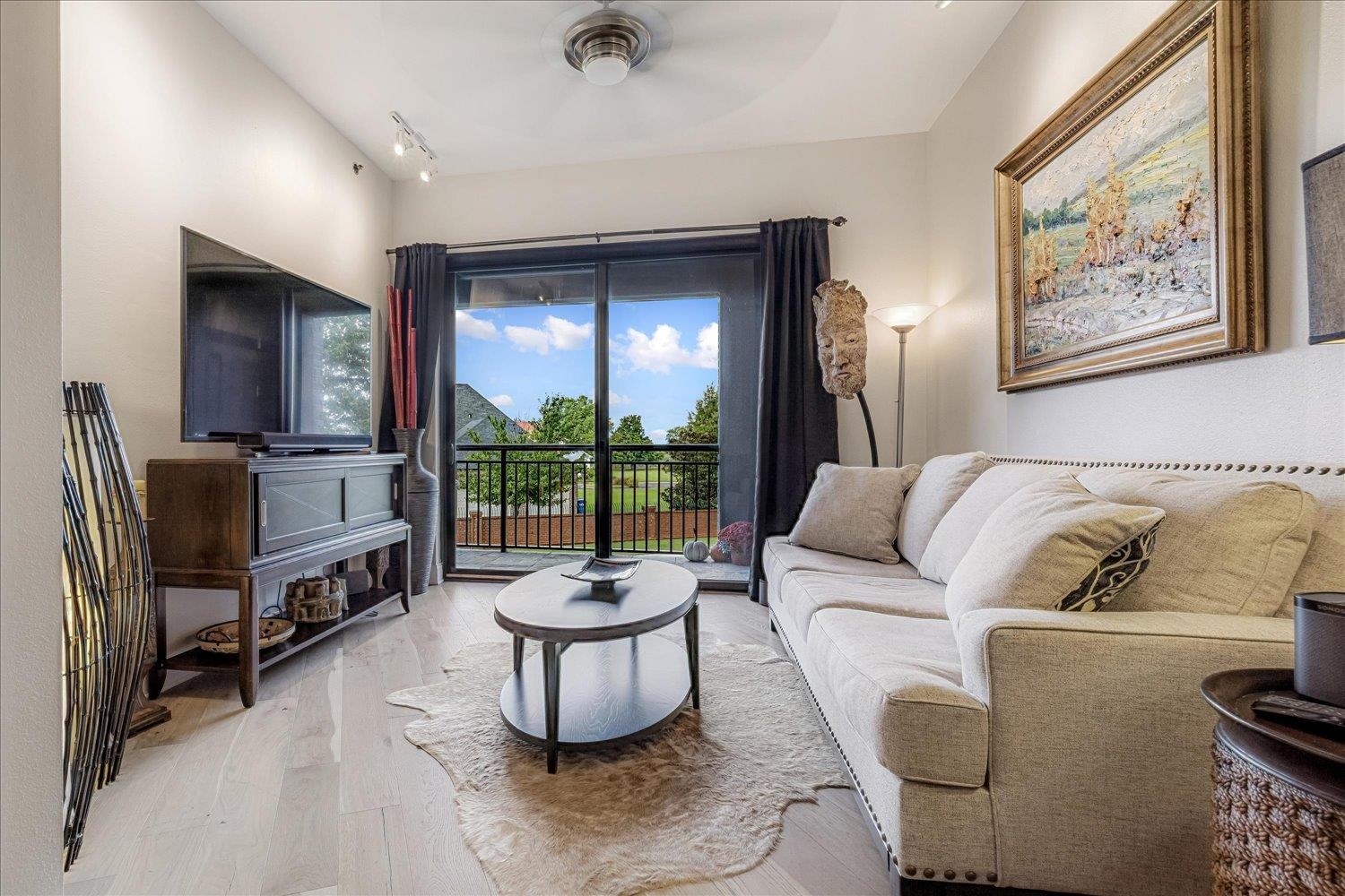 717 Riverside Drive, Unit 207 Memphis, TN 38103 - Photo 16 of 30 a living room with furniture and a floor to ceiling window