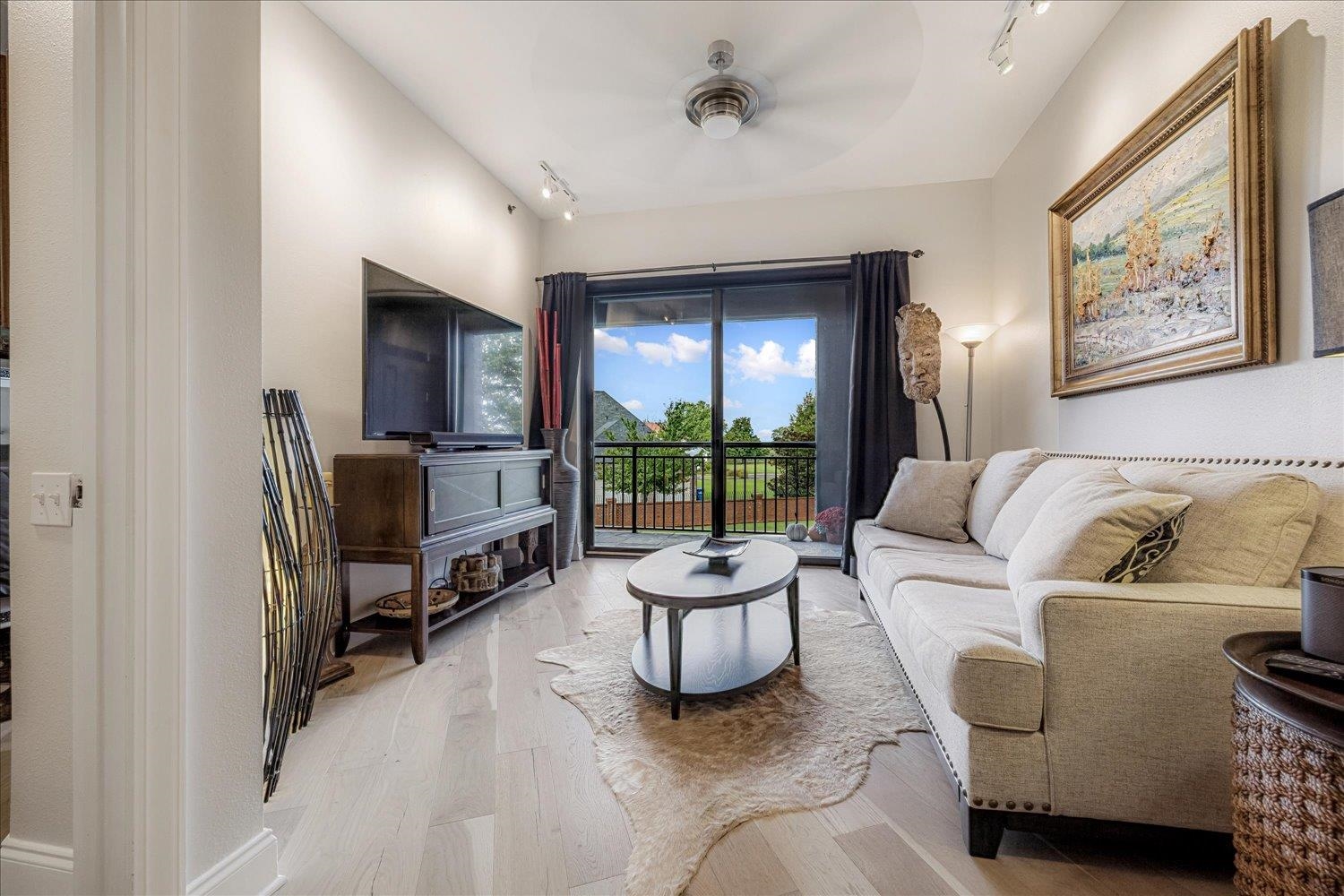 717 Riverside Drive, Unit 207 Memphis, TN 38103 - Photo 17 of 30 a living room with furniture and a flat screen tv