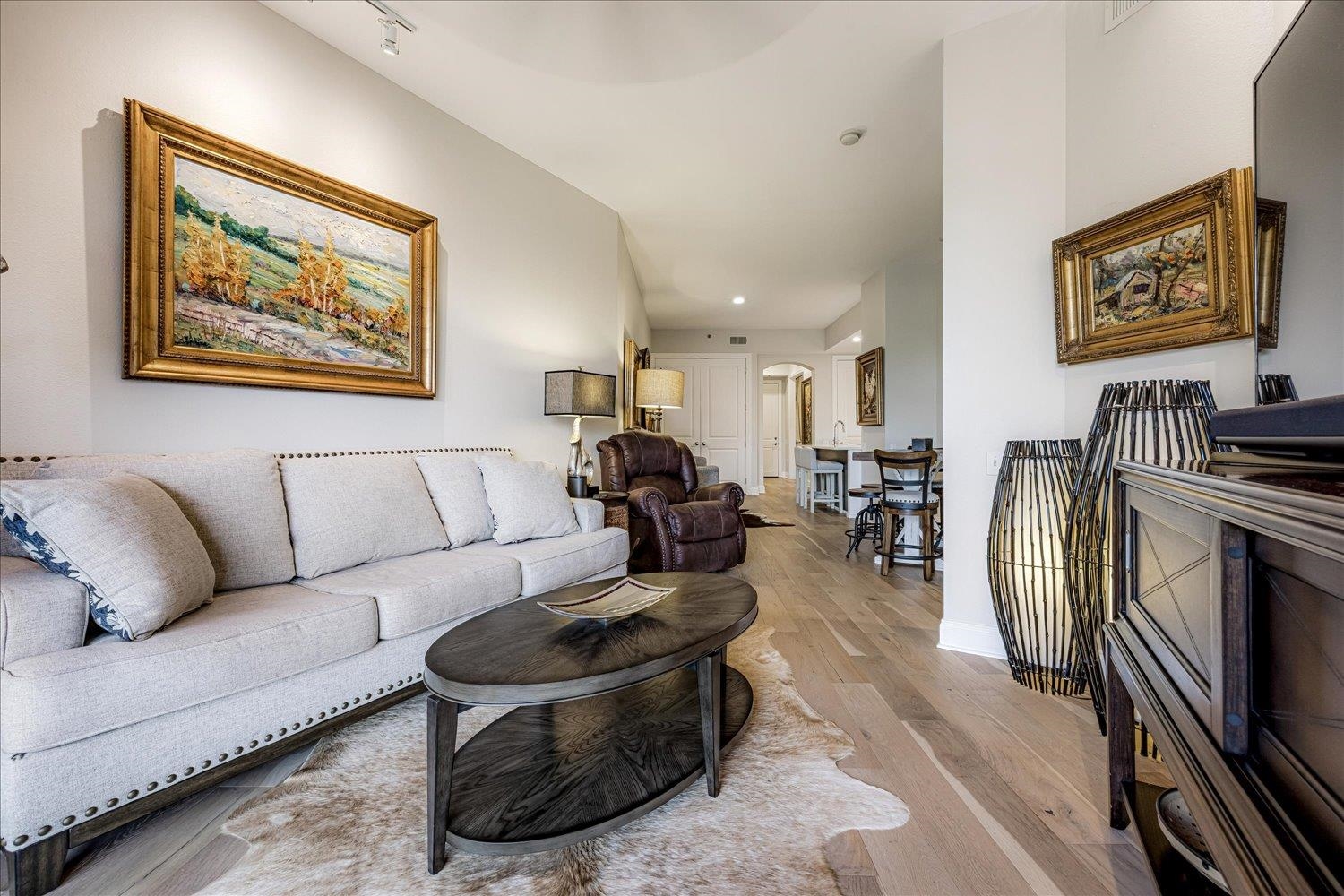 717 Riverside Drive, Unit 207 Memphis, TN 38103 - Photo 20 of 30 a living room with furniture a rug and wall painting