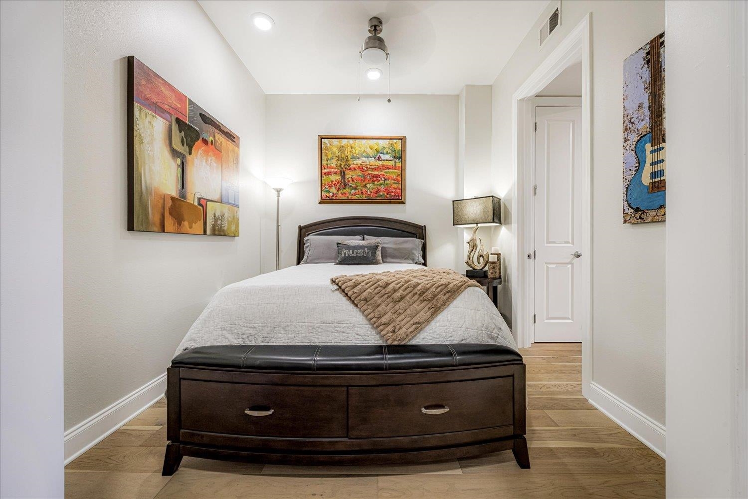 717 Riverside Drive, Unit 207 Memphis, TN 38103 - Photo 4 of 30 a bedroom with a bed and wall painting