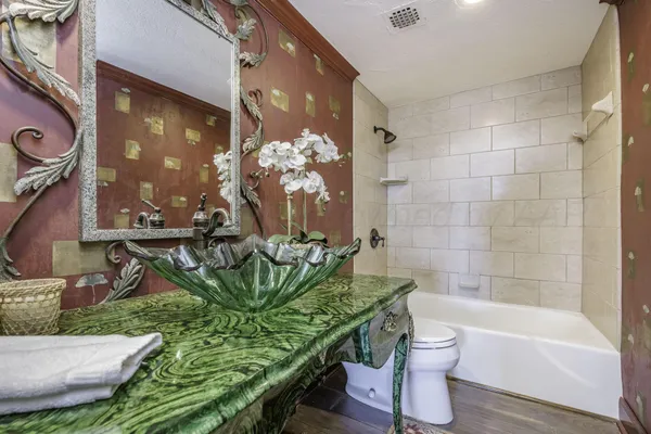 a bathroom with a sink toilet and shower