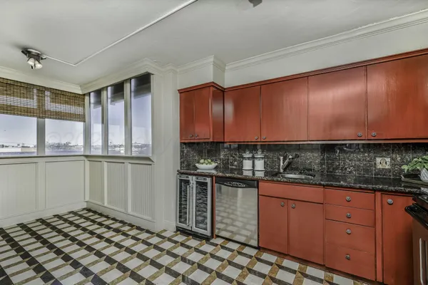 a kitchen with granite countertop a sink and cabinets