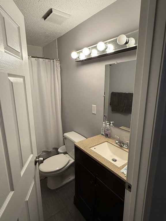 100 Captains Row, Unit 203 Chelsea, MA 02150 - Photo 2 of 16 a bathroom with a sink a toilet and mirror