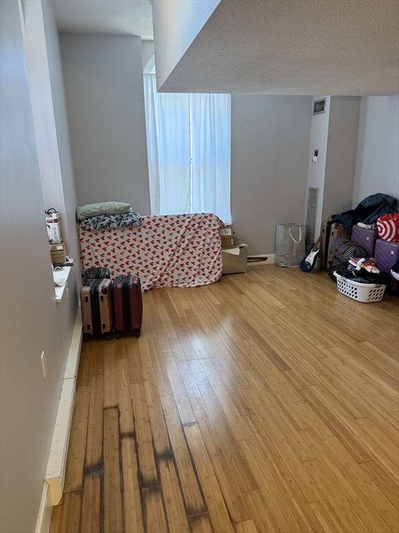 100 Captains Row, Unit 203 Chelsea, MA 02150 - Photo 7 of 16 a view of a room with wooden floor and furniture