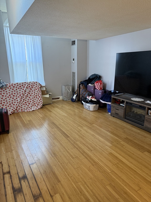 100 Captains Row, Unit 203 Chelsea, MA 02150 - Photo 8 of 16 a view of a livingroom with furniture and a flat screen tv