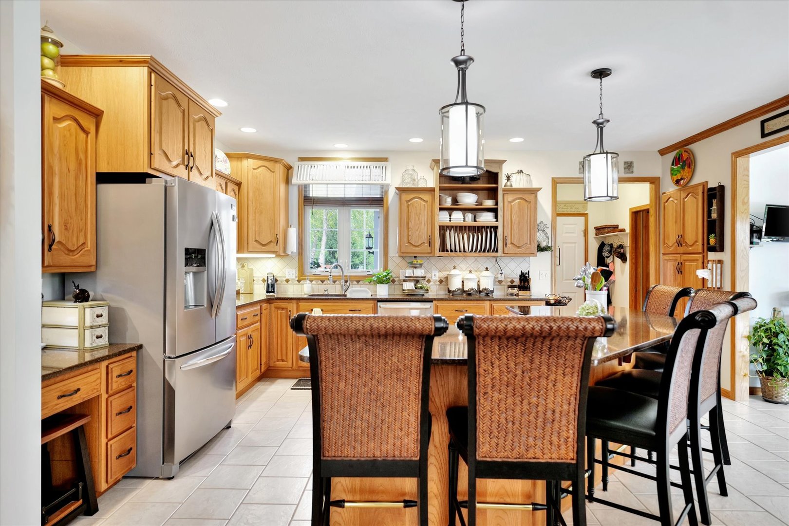 3002 Country Bend Lane Champaign, IL 61822 - Photo 8 of 48 a kitchen with granite countertop a refrigerator a stove a sink and a dining table with wooden floor