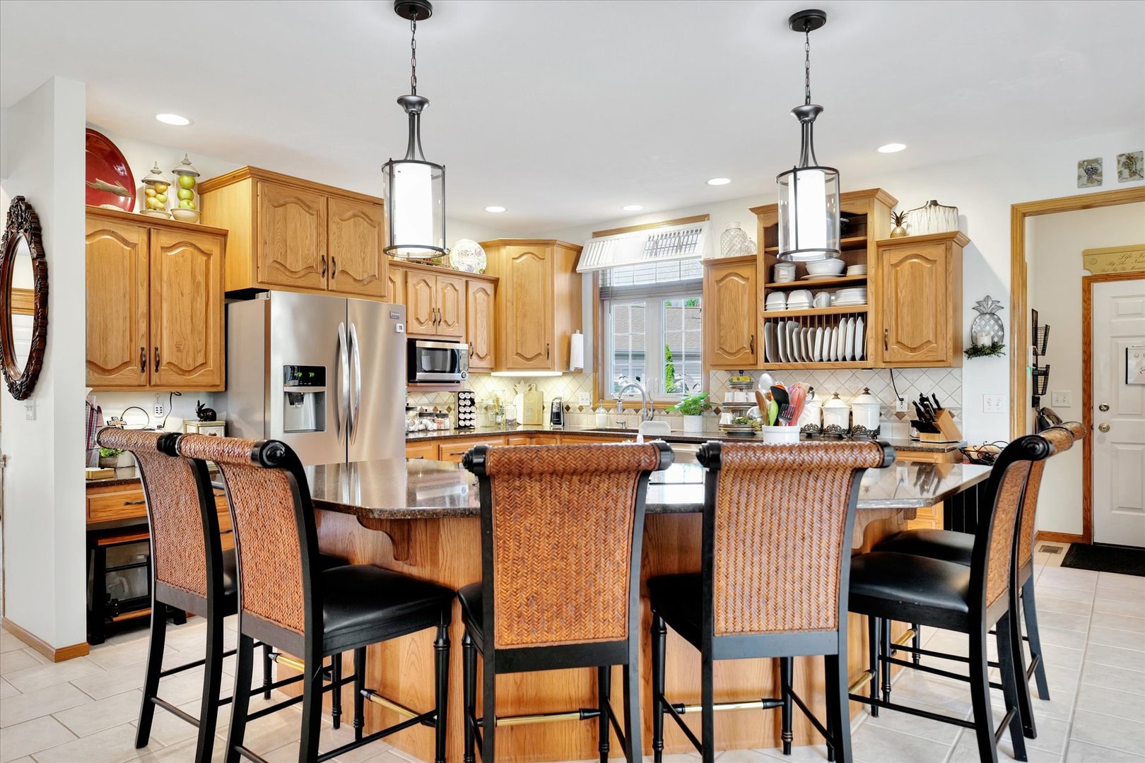 3002 Country Bend Lane Champaign, IL 61822 - Photo 9 of 48 a dining room with stainless steel appliances kitchen island granite countertop a dining table chairs and a refrigerator