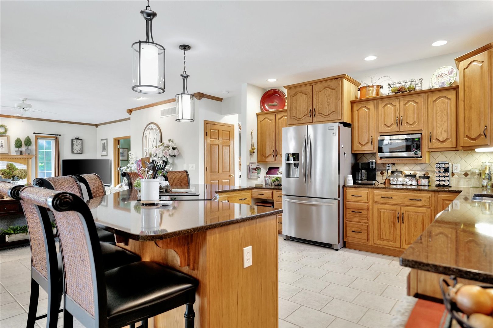 3002 Country Bend Lane Champaign, IL 61822 - Photo 10 of 48 a kitchen with refrigerator cabinets dining table and chairs