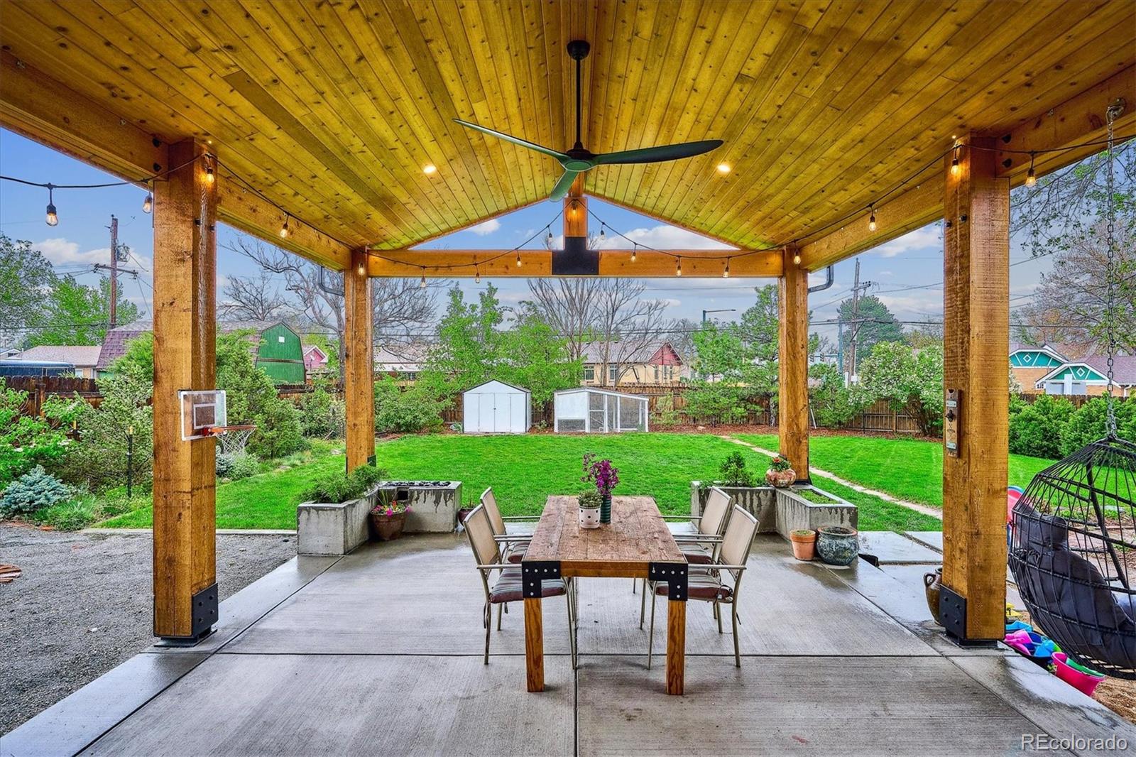 3200 Ames Street Wheat Ridge, CO 80212 - Photo 1 of 46 a view of a patio with a table chairs and a backyard