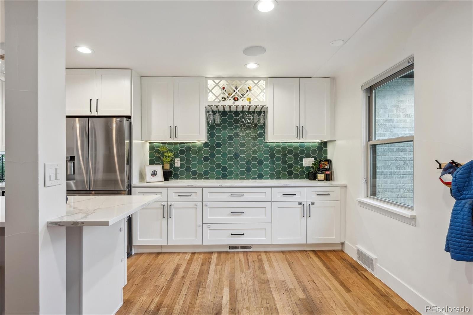 3200 Ames Street Wheat Ridge, CO 80212 - Photo 14 of 46 a kitchen with granite countertop white cabinets and stainless steel appliances