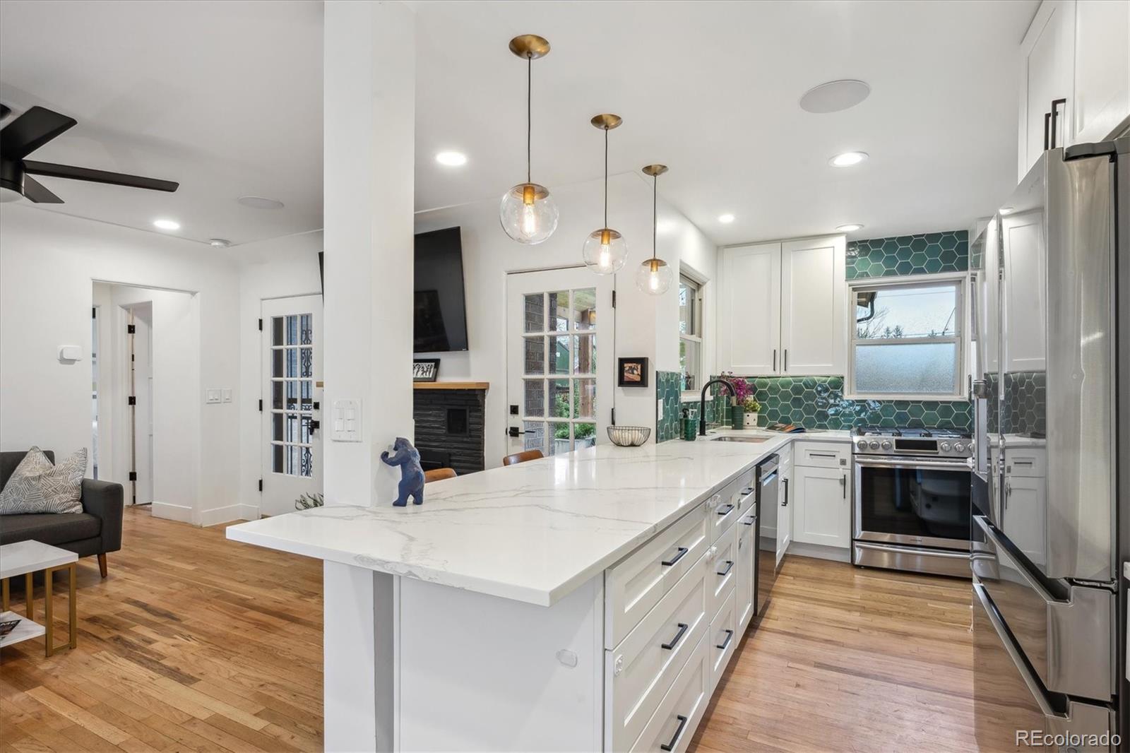 3200 Ames Street Wheat Ridge, CO 80212 - Photo 16 of 46 a large kitchen with kitchen island a large island in it