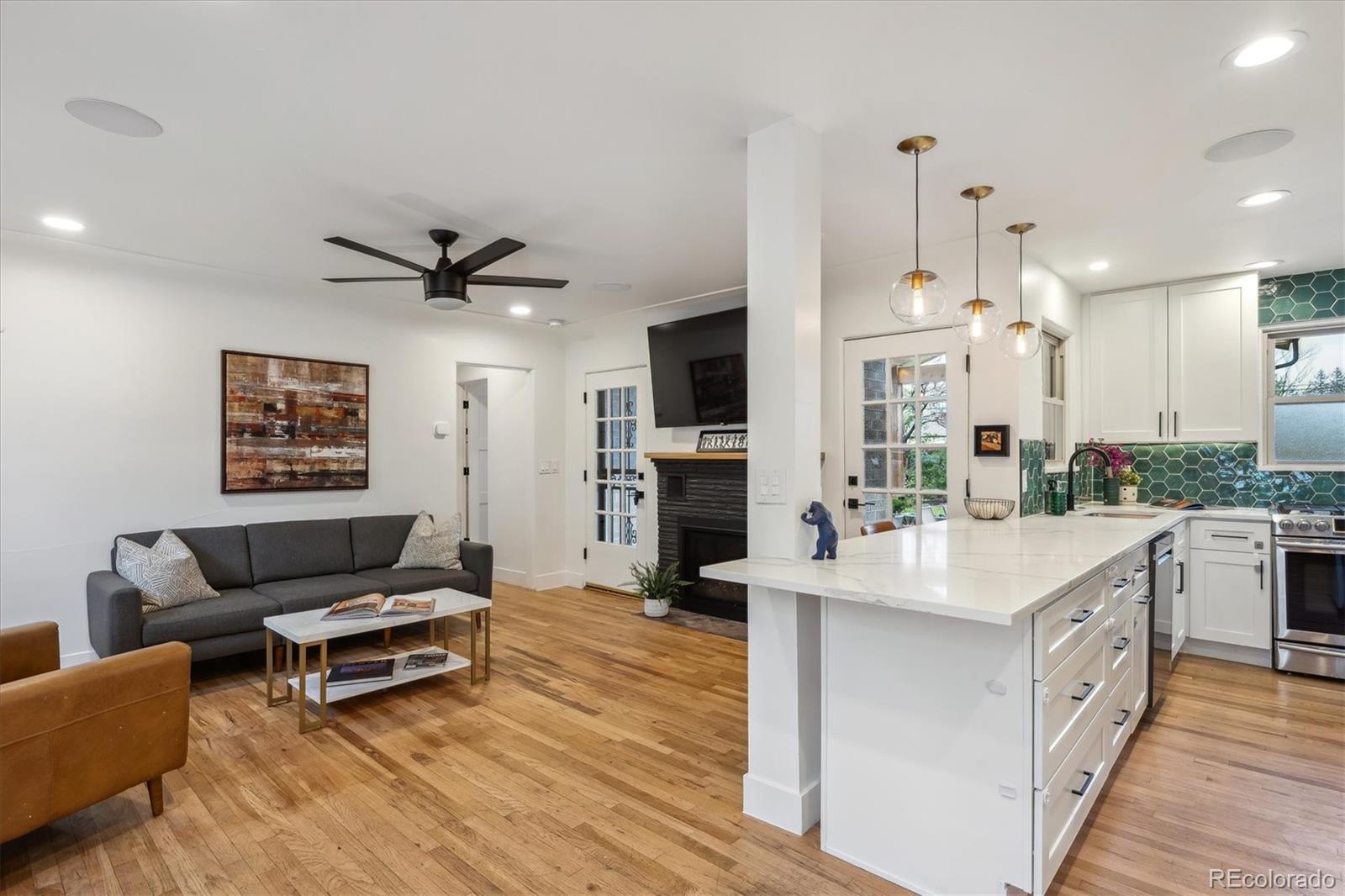 3200 Ames Street Wheat Ridge, CO 80212 - Photo 17 of 46 a living room with stainless steel appliances kitchen island granite countertop furniture and a fireplace