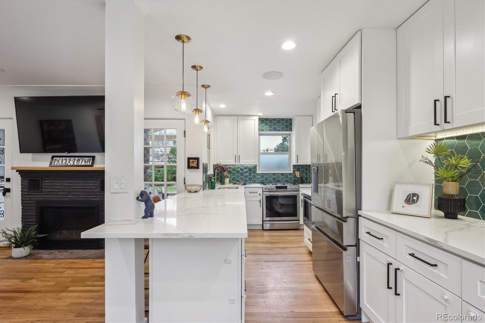 3200 Ames Street Wheat Ridge, CO 80212 - Photo 18 of 46 a kitchen with refrigerator a stove and furniture