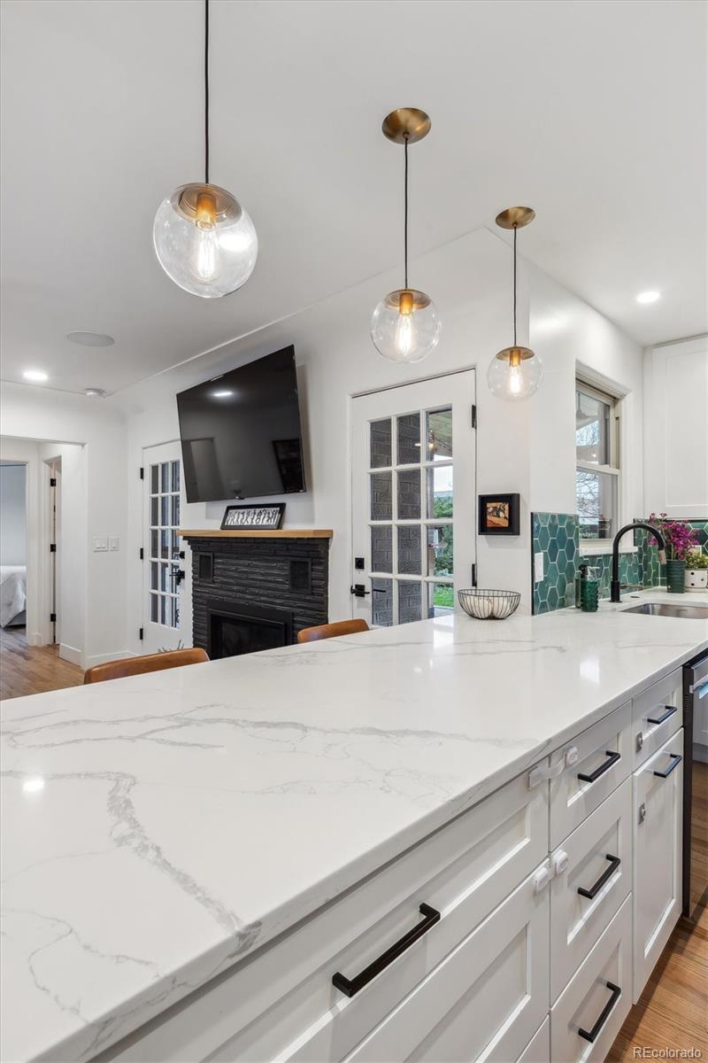 3200 Ames Street Wheat Ridge, CO 80212 - Photo 20 of 46 a kitchen with stainless steel appliances a stove refrigerator and a wooden floor