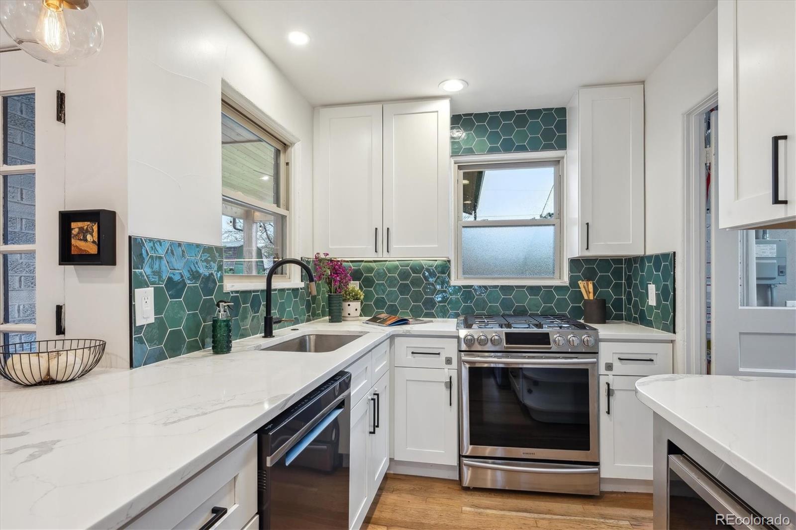 3200 Ames Street Wheat Ridge, CO 80212 - Photo 21 of 46 a kitchen with a stove and a sink