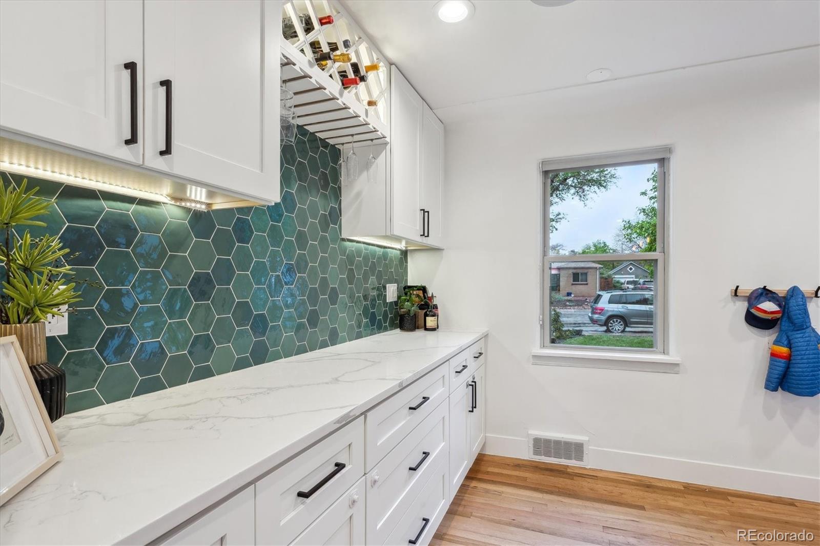 3200 Ames Street Wheat Ridge, CO 80212 - Photo 25 of 46 a bathroom with a sink a mirror and a shower