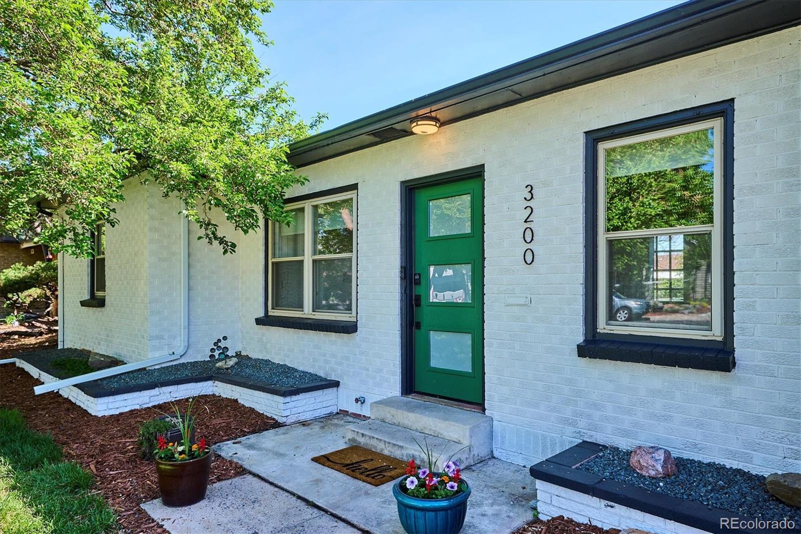 3200 Ames Street Wheat Ridge, CO 80212 - Photo 3 of 46 a front view of a house with porch
