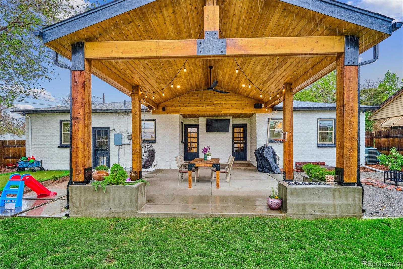 3200 Ames Street Wheat Ridge, CO 80212 - Photo 32 of 46 a view of the house with a backyard and a patio