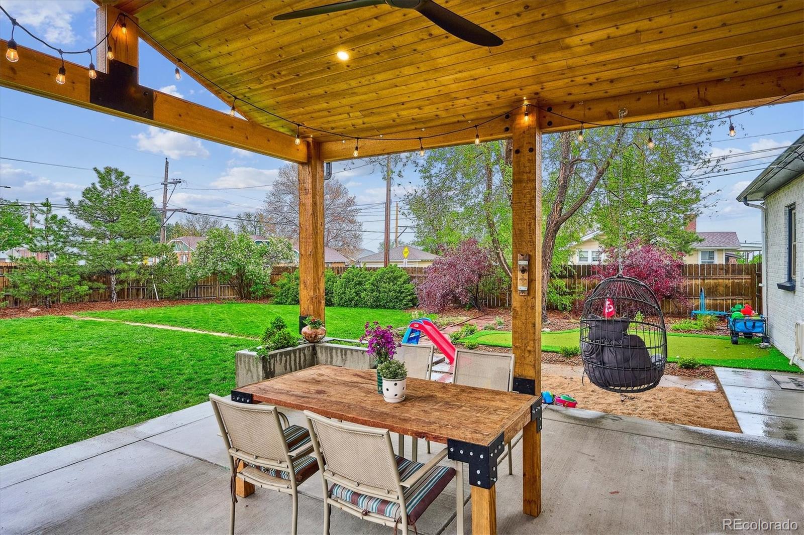 3200 Ames Street Wheat Ridge, CO 80212 - Photo 34 of 46 a view of an outdoor dining space with a table and chairs in patio