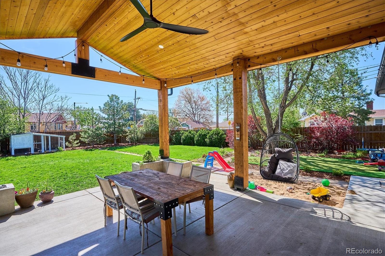 3200 Ames Street Wheat Ridge, CO 80212 - Photo 40 of 46 a view of a patio with a table chairs and a backyard