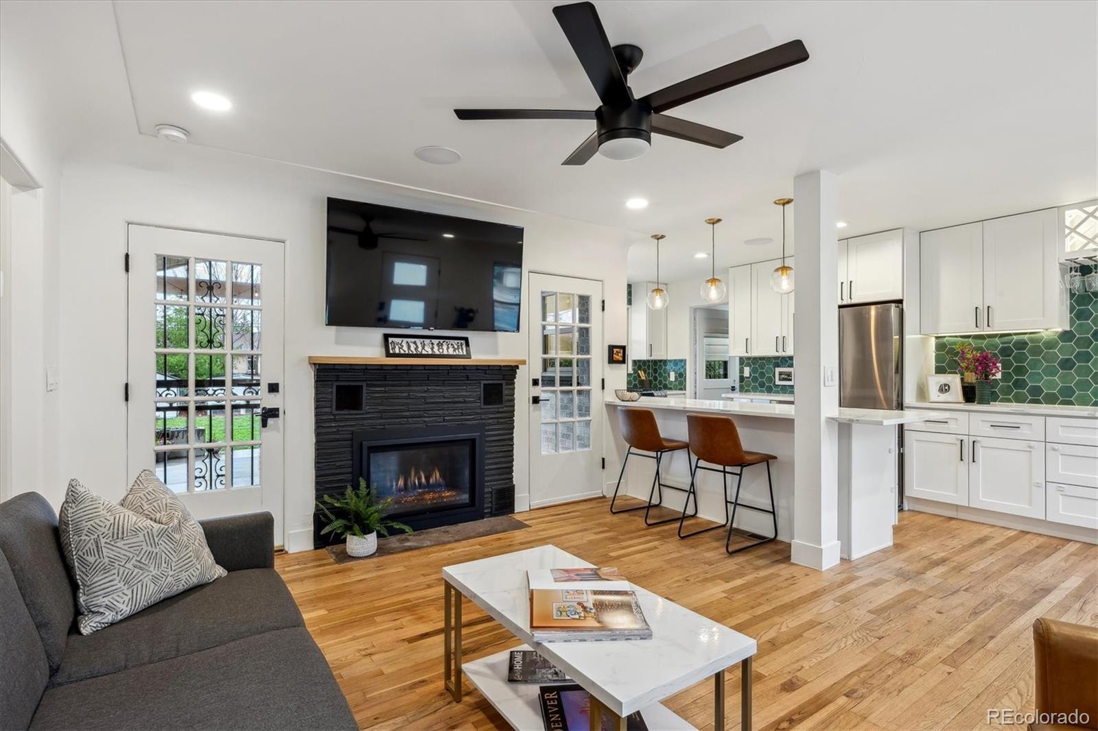 3200 Ames Street Wheat Ridge, CO 80212 - Photo 5 of 46 a living room with furniture and a fireplace
