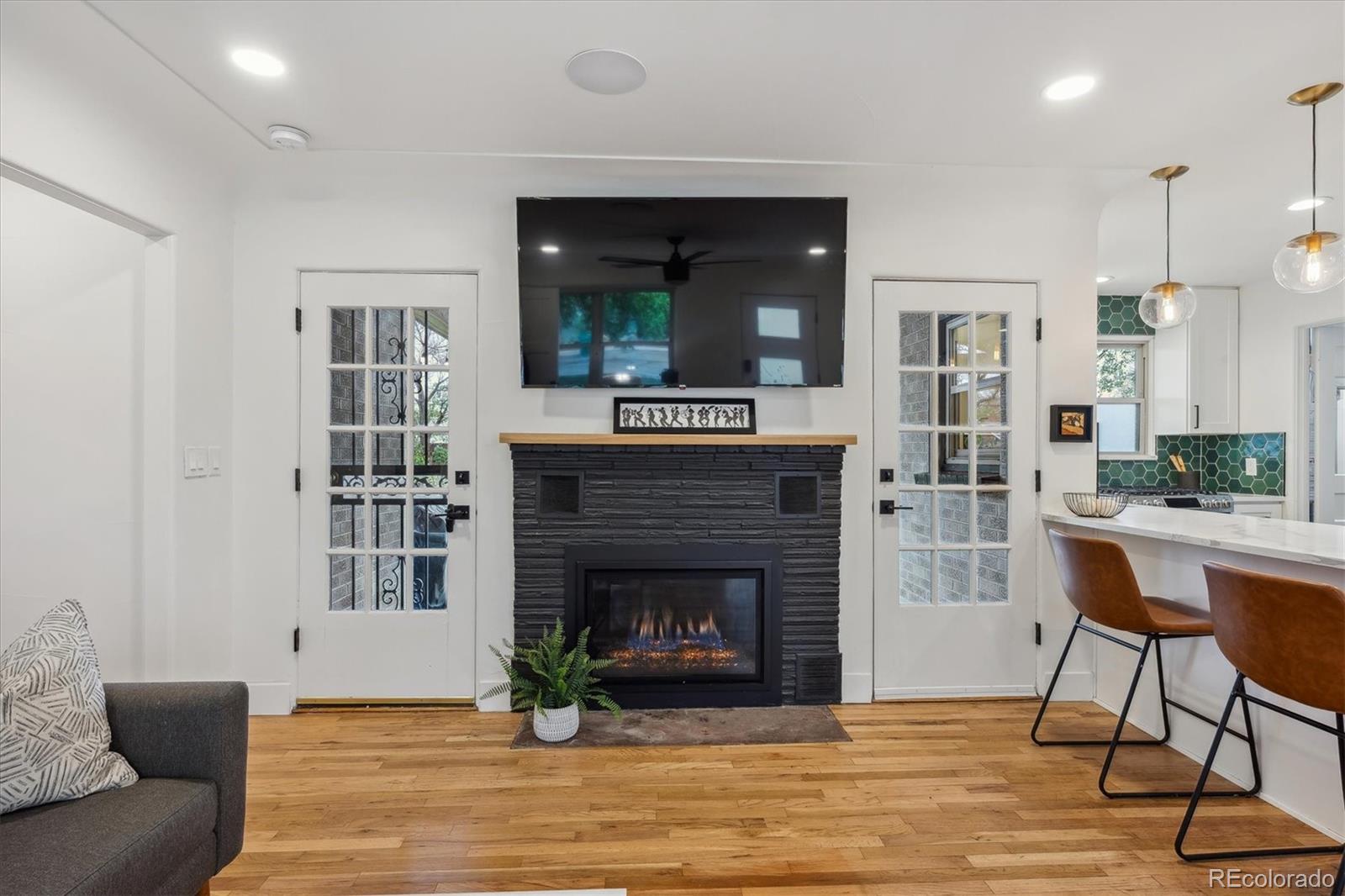 3200 Ames Street Wheat Ridge, CO 80212 - Photo 6 of 46 a living room with furniture and a fireplace