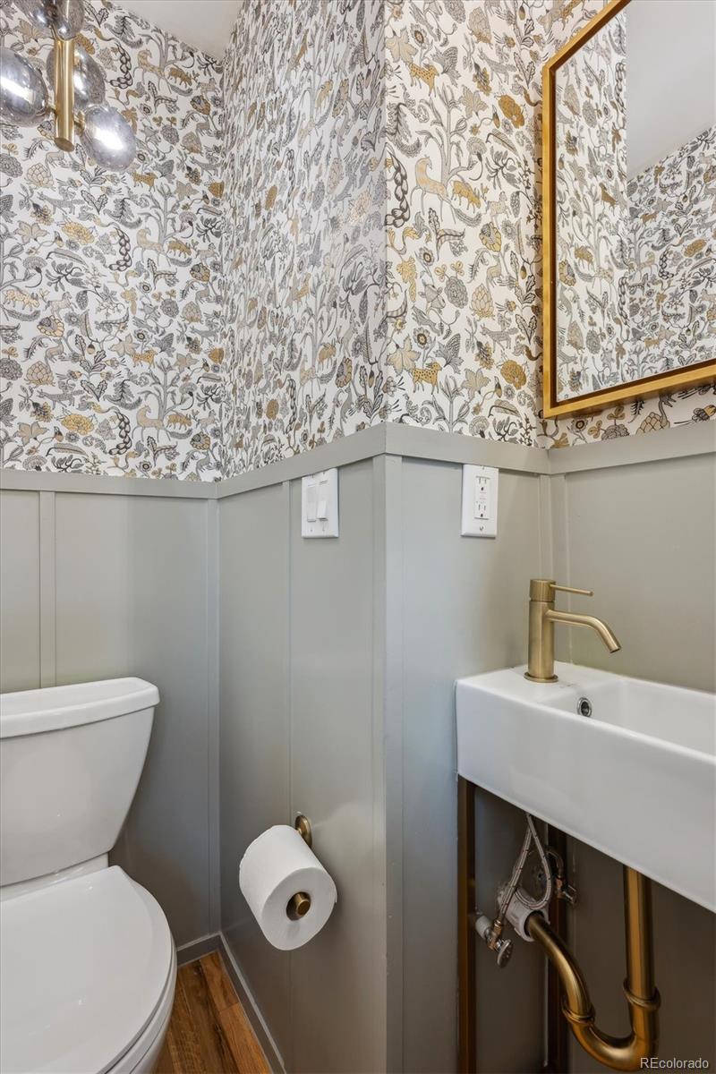 3200 Ames Street Wheat Ridge, CO 80212 - Photo 10 of 46 a bathroom with a toilet a sink and mirror