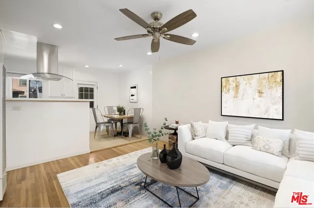 a living room with furniture and kitchen view