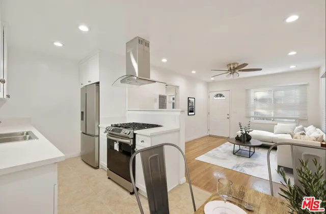 a kitchen with a stove a sink and a refrigerator