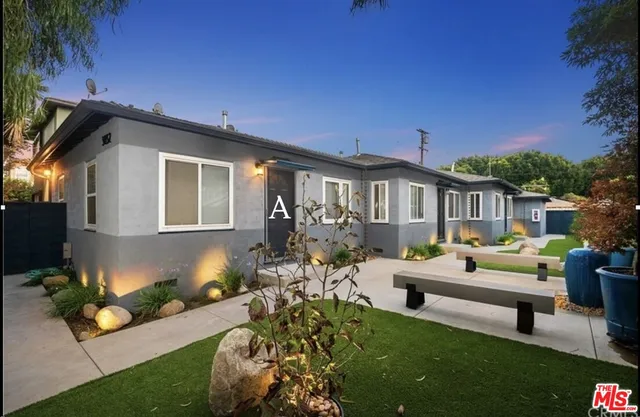 a front view of a house with garden