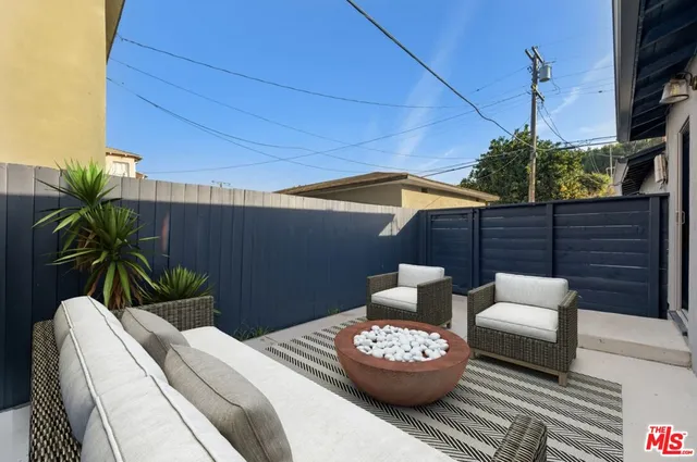 a view of a patio with couches and potted plants