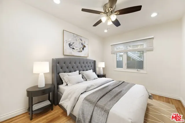 a bedroom with a large bed and a chandelier