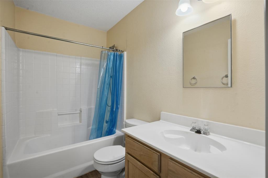 8704 Serenity Way Denton, TX 76210 - Photo 17 of 29 a bathroom with a sink toilet and shower