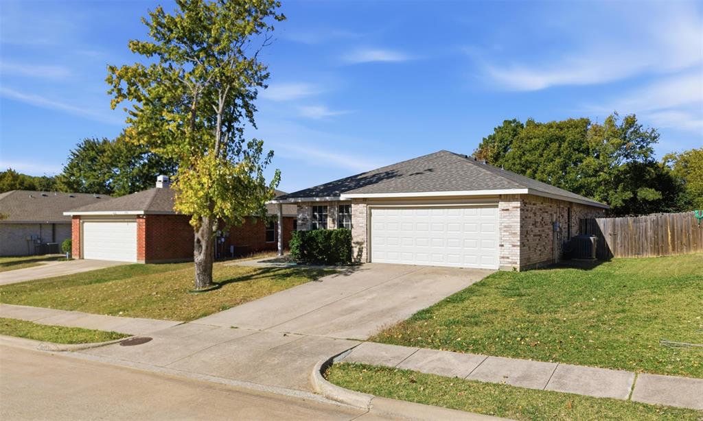 8704 Serenity Way Denton, TX 76210 - Photo 2 of 29 a front view of a house with a yard and garage