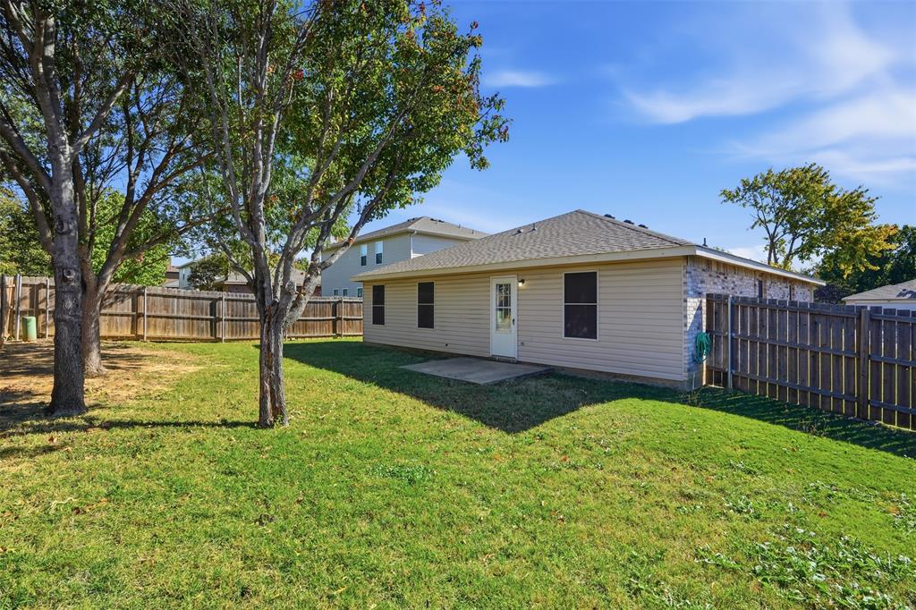8704 Serenity Way Denton, TX 76210 - Photo 22 of 29 a view of a yard in front of a house with large trees