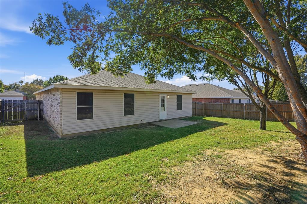 8704 Serenity Way Denton, TX 76210 - Photo 23 of 29 a front view of a house with garden