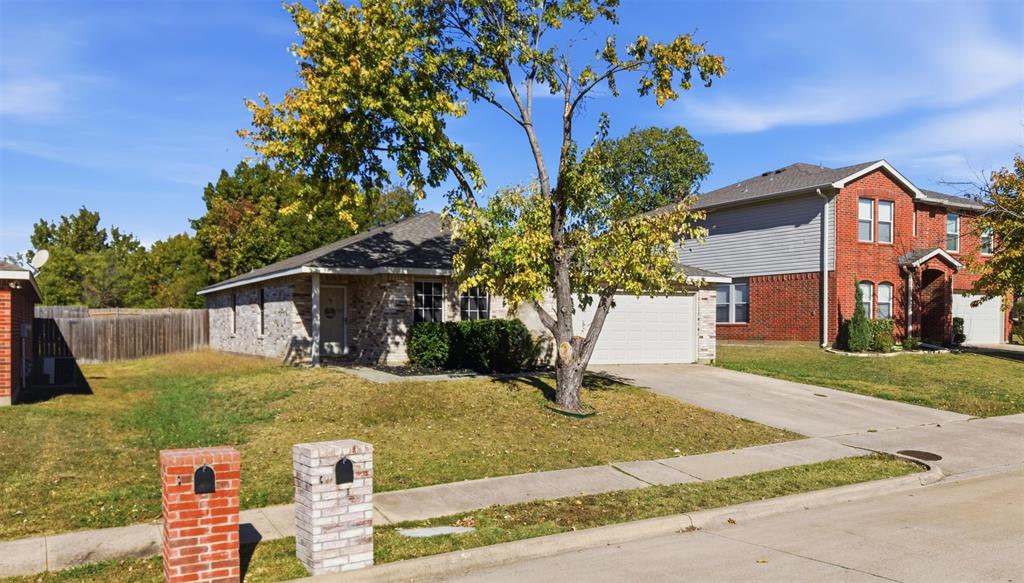 8704 Serenity Way Denton, TX 76210 - Photo 4 of 29 a front view of a house with garden