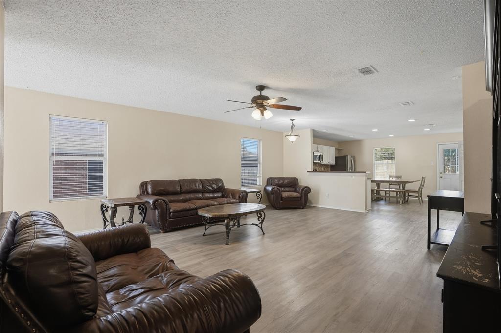 8704 Serenity Way Denton, TX 76210 - Photo 8 of 29 a living room with furniture and a large window