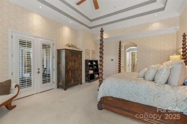 a view of a hallway with wooden floor and a bathroom