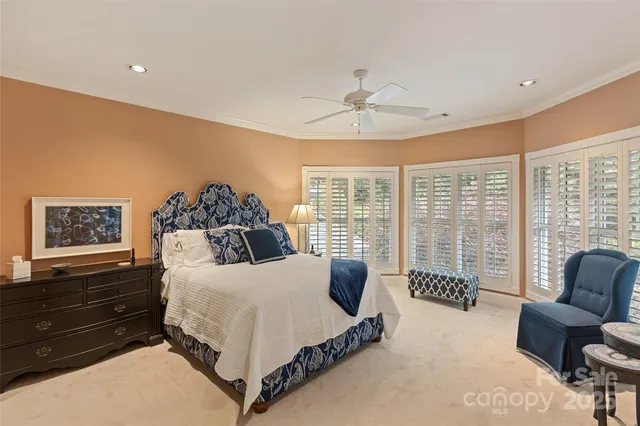 a view of swimming pool with wooden floor and seating space