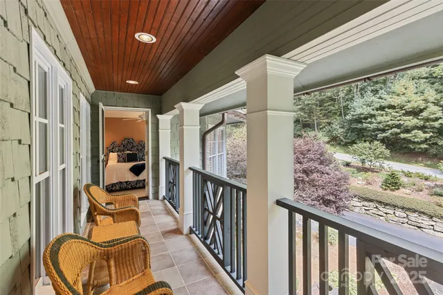 a bedroom with a bed a couch and a window