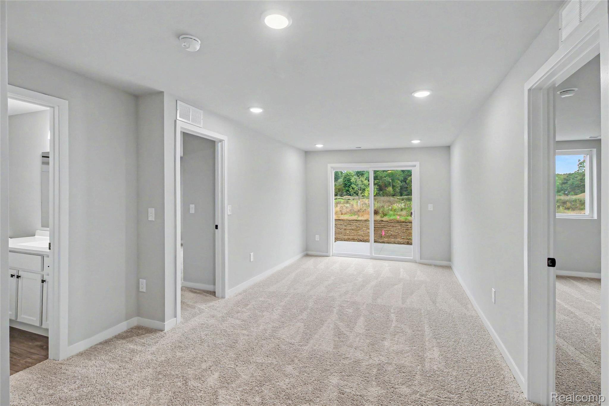 1210 Lockes Street Howell, MI 48843 - Photo 14 of 37 The lower level includes another common space with direct access to the back yard, 3 spacious bedrooms, a full bath and utility room equipped with washer & dryer