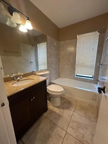a bathroom with a double vanity sink toilet mirror and shower