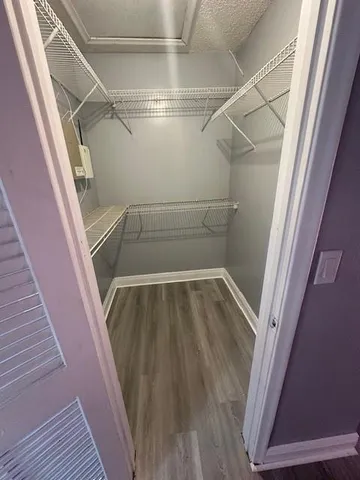 a view of walk in closet with empty racks